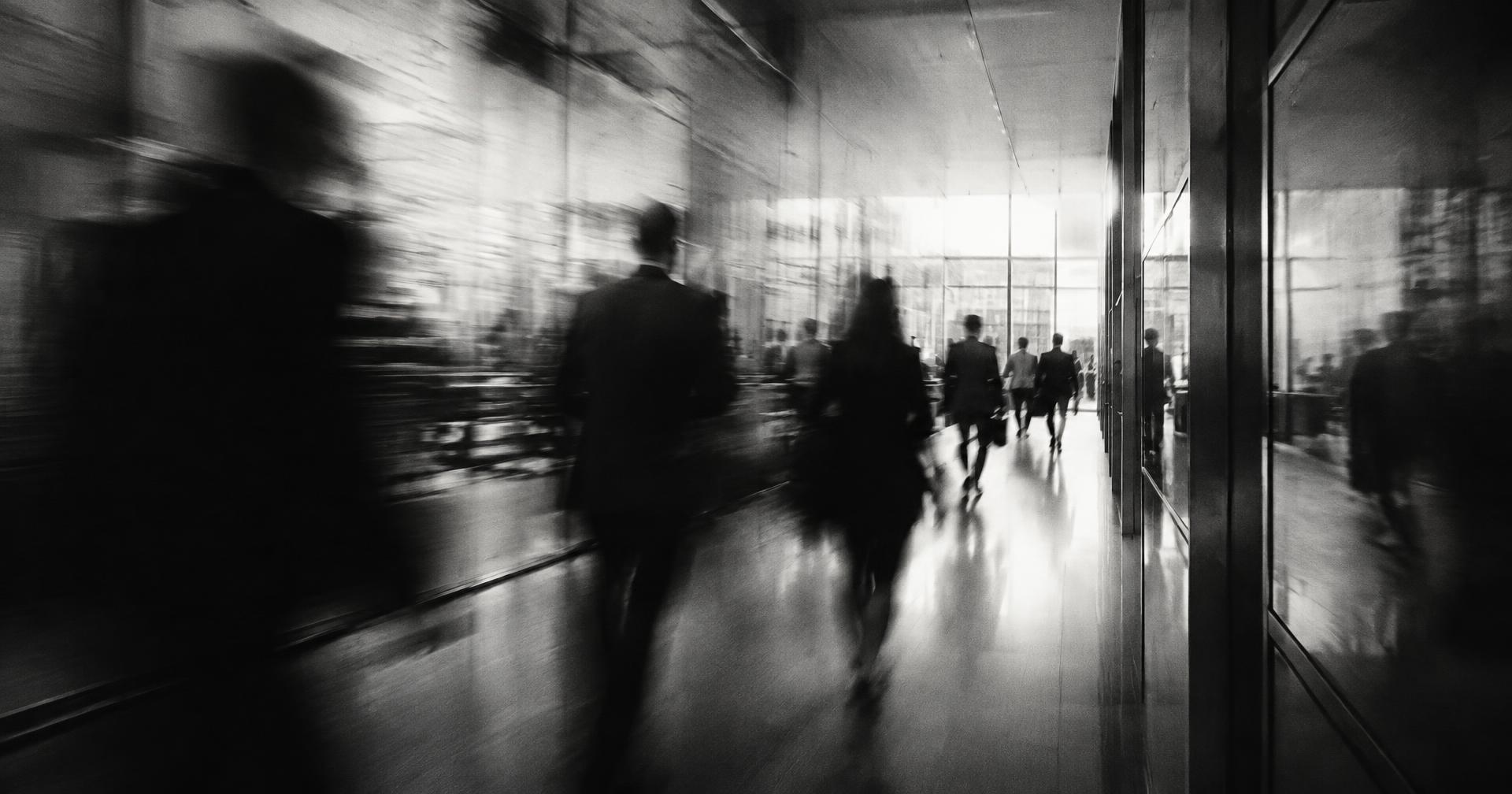 Engineers moving through a startup office, captured in long exposure